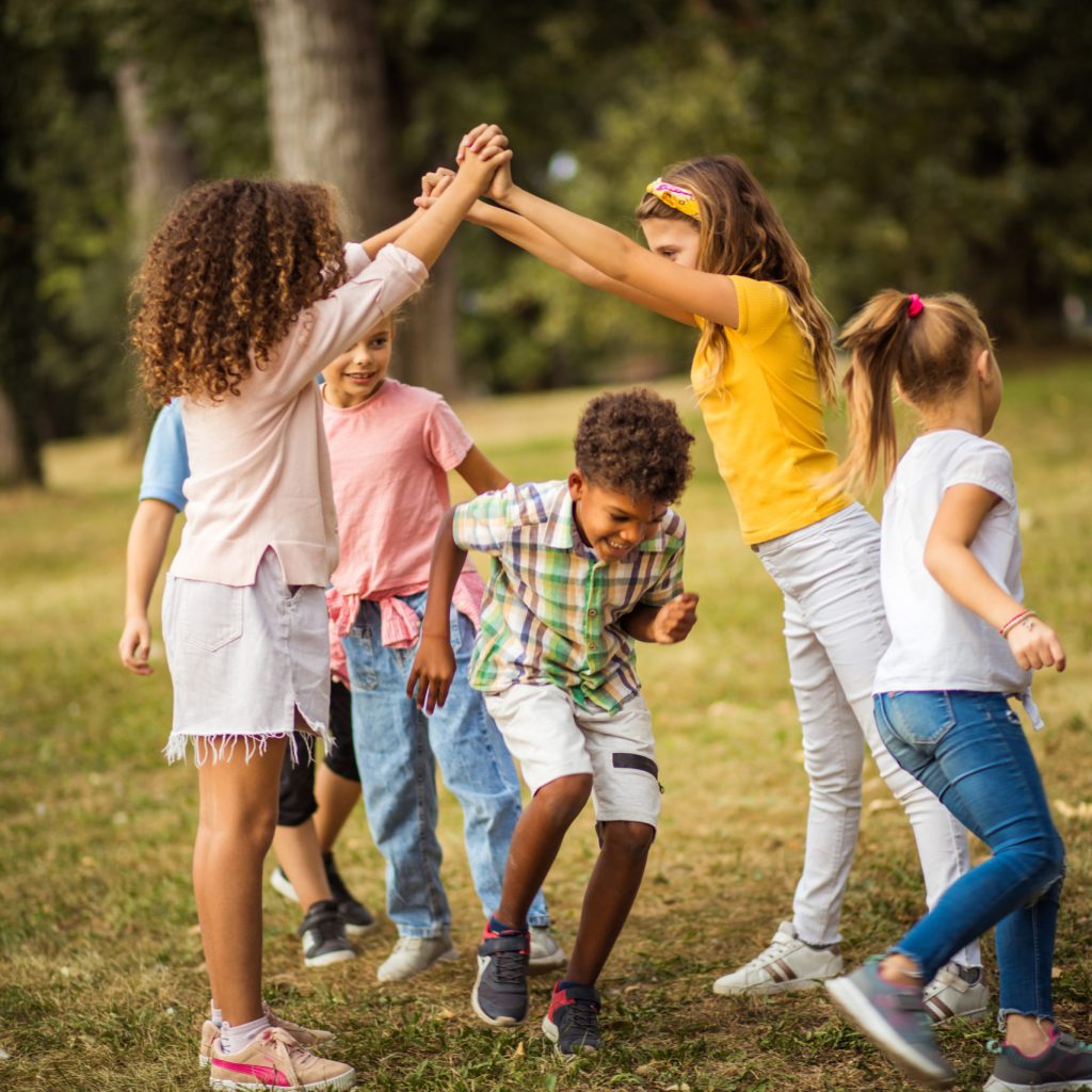 Large group of school kids having fun in nature.